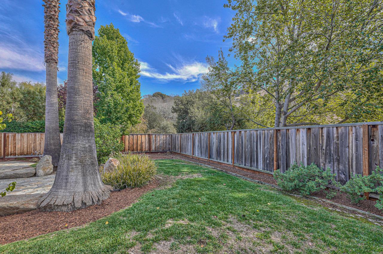 17644 River Run Road Salinas, CA 93908 - Photo 25 of 41 a view of a backyard with potted plants and wooden fence