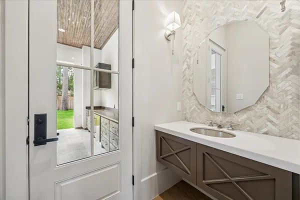 a kitchen with a sink cabinets and wooden floor