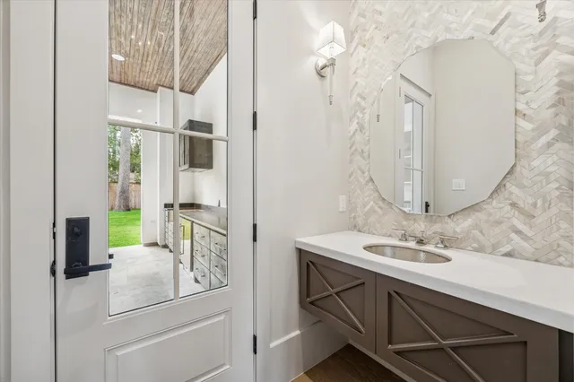 a kitchen with a sink cabinets and wooden floor