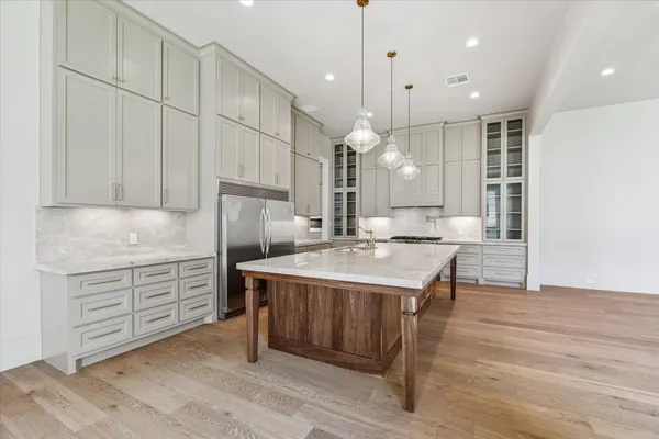 a kitchen with stainless steel appliances granite countertop a sink a stove and a granite counter tops