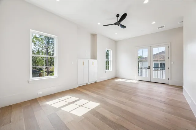 a spacious bathroom with a tub shower and window