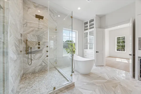 a large white bathroom with a double vanity sink a mirror and a