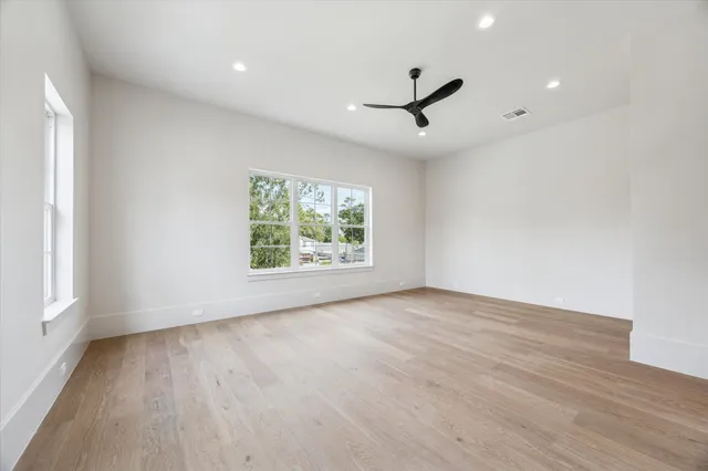 a bathroom with a granite countertop sink a mirror and shower