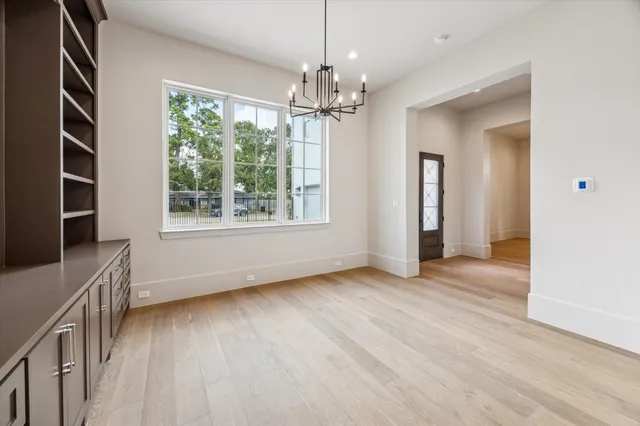 a large kitchen with kitchen island a large counter space a sink stainless steel appliances and cabinets