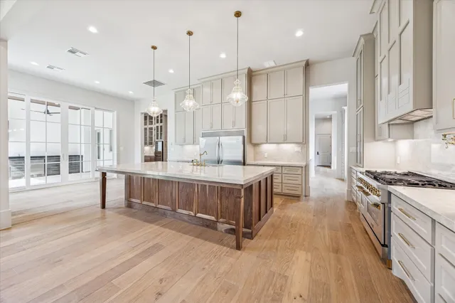a kitchen with a stove a sink and a refrigerator