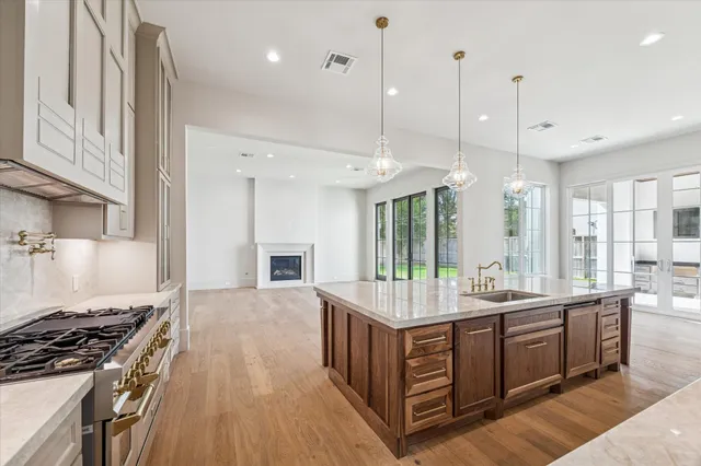 a view of empty room with wooden floor and fireplace