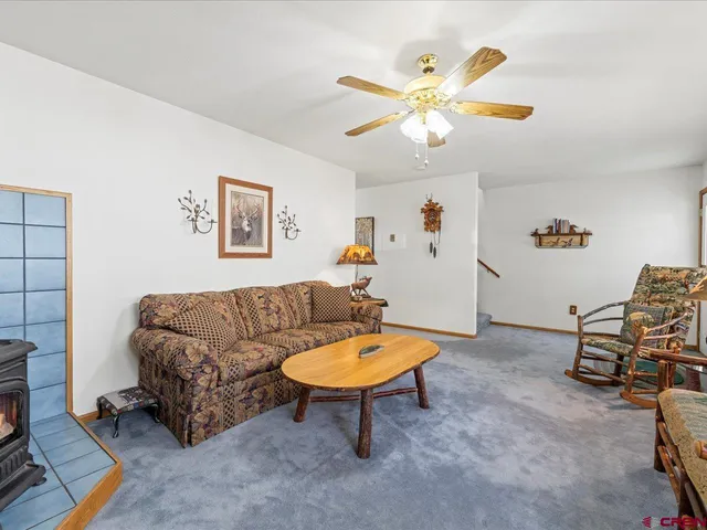 a living room with furniture a rug and a window