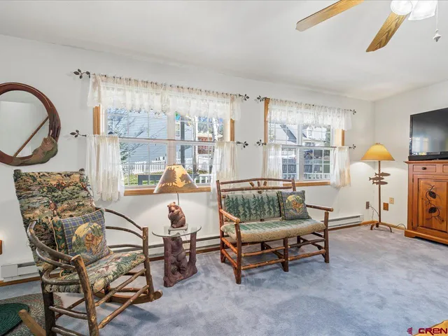 a living room with furniture and a floor to ceiling window