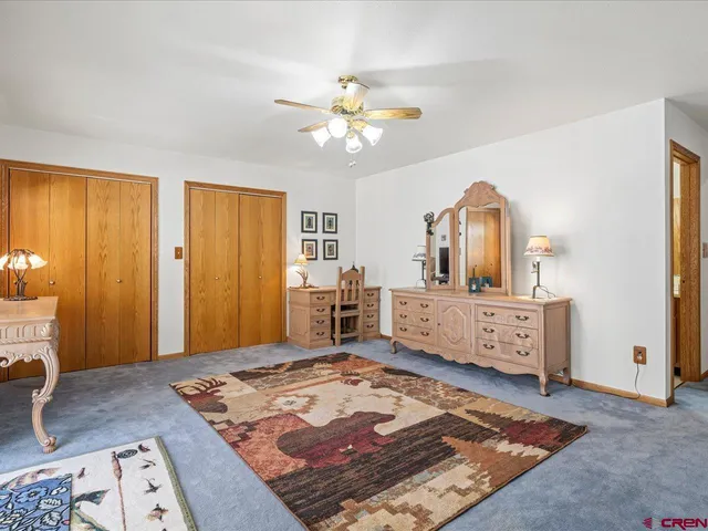 a living room with a bed furniture and a dresser