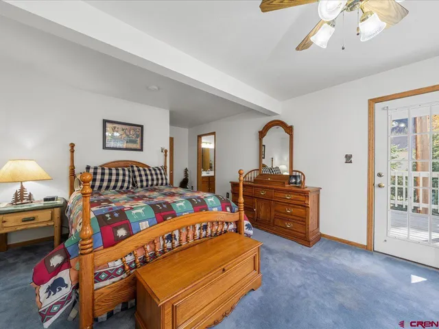 a bedroom with a bed and a dresser in it