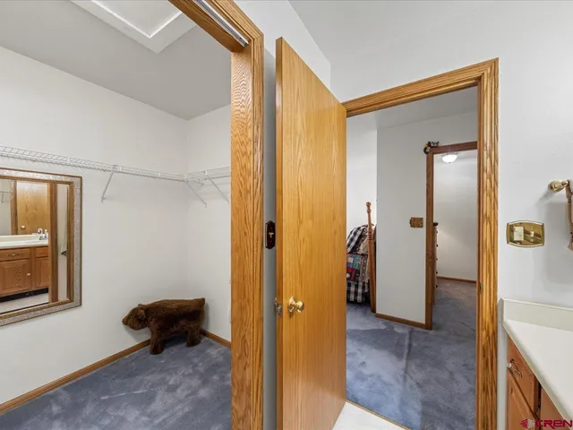 a view of a hallway and a livingroom and a livingroom with furniture