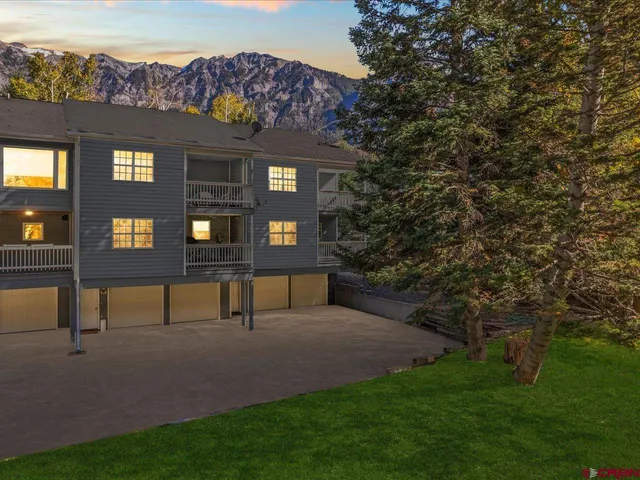 a view of a brick house with a yard