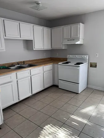 a kitchen with cabinets and appliances