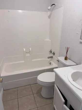 a bathroom with a sink a toilet and bathtub