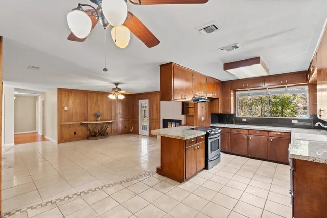 a bedroom with a large bed and a ceiling fan