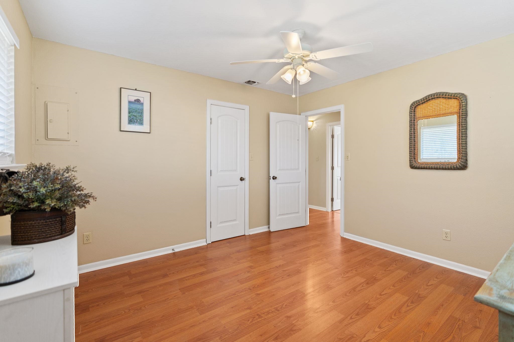 418 Hernandos Loop Leander, TX 78641 - Photo 16 of 24 a view of an empty room with wooden floor and a potted plant