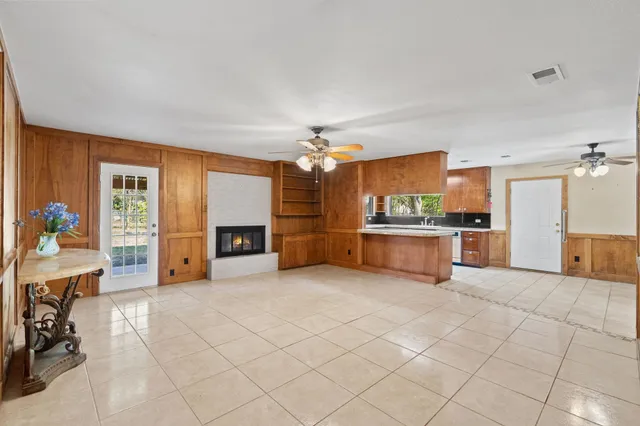 a living room with fireplace furniture and a chandelier