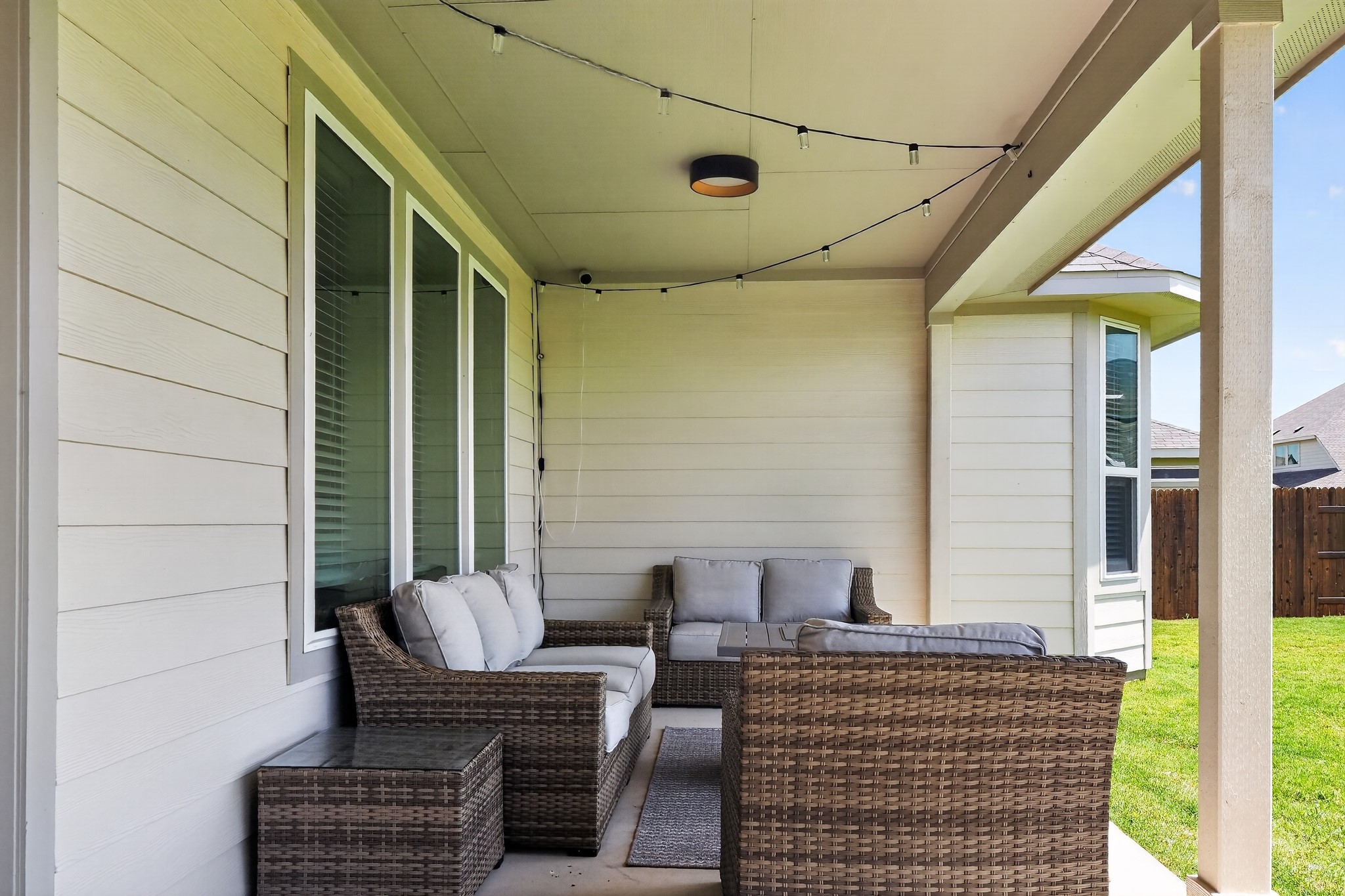 114 Bosco Road Hutto, TX 78634 - Photo 36 of 39 A sheltered patio area with ample seating offers an inviting space for relaxation outdoors.