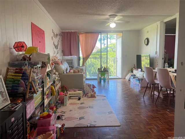 a living room filled with furniture and a gym