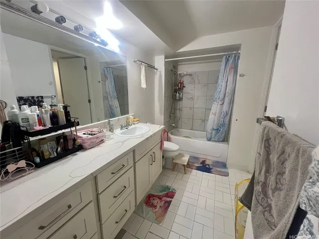 a spacious bathroom with a double vanity sink a toilet a mirror and shower