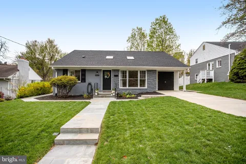 a front view of a house with yard patio and green space