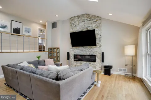 a living room with furniture fireplace and a flat screen tv