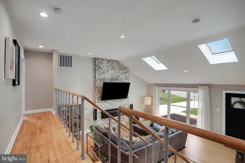 a hallway with wooden floor and furniture