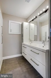 a bedroom with a bed and a table in it with window