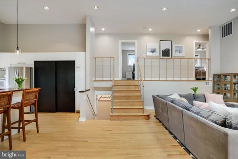 a living room with furniture and a wooden floor