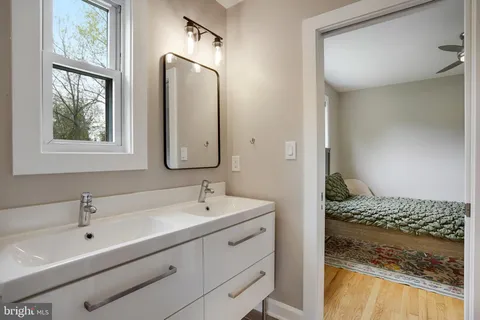 a living room with furniture a flat screen tv and a floor to ceiling window
