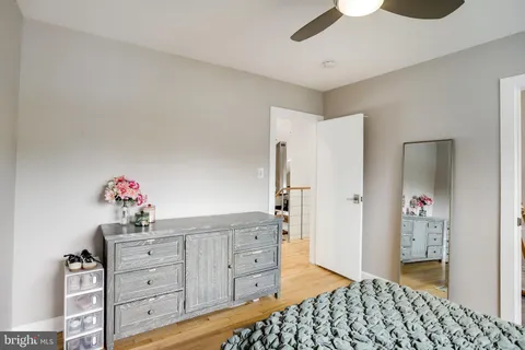 a large bedroom with a bed and a flat screen tv