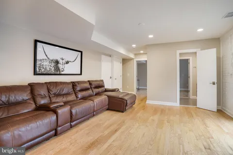 a view of an empty room with a ceiling fan and window