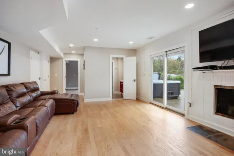 a view of a room with wooden floor a ceiling fan