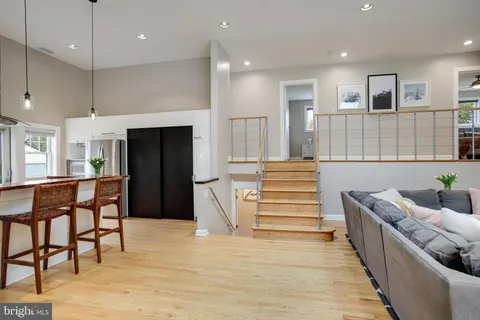 a kitchen with stainless steel appliances kitchen island granite countertop a refrigerator and a sink