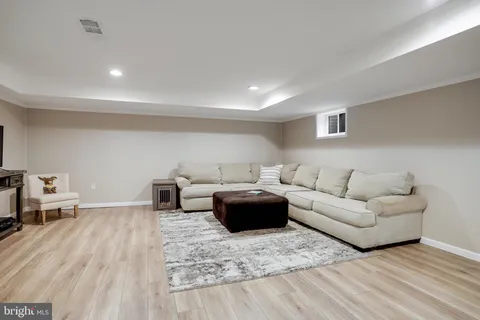 a view of a house with backyard sitting area and garden