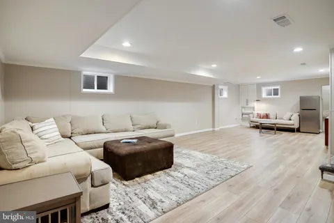 a view of a patio with couches table and chairs and potted plants