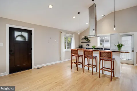 a kitchen with stainless steel appliances kitchen island granite countertop a refrigerator and a stove top oven