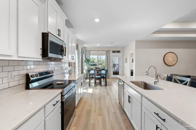 a kitchen with furniture a counter space a sink and appliances