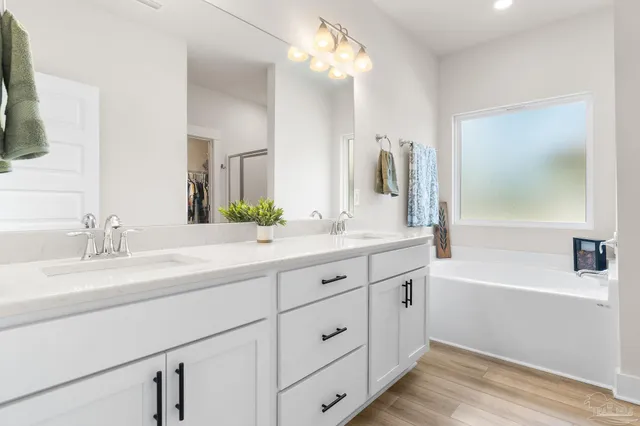 a bathroom with a double vanity sink and a mirror