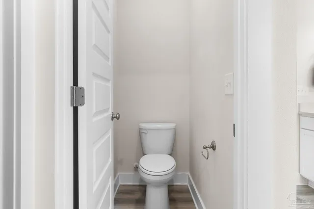 a white toilet sitting next to a white cabinet