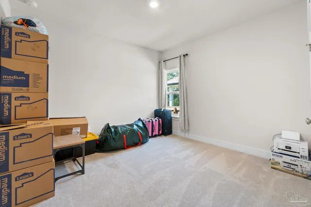 a bedroom with furniture and a window