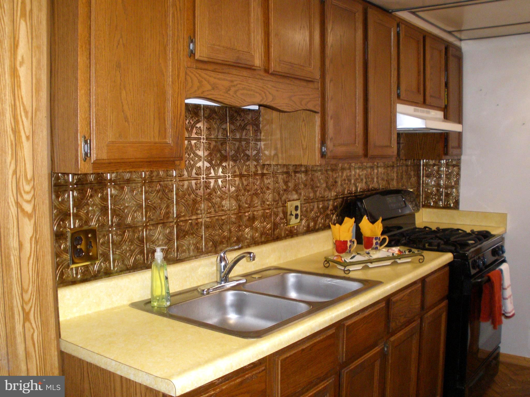 38 Kinship Road Baltimore, MD 21222 - Photo 5 of 38 a kitchen with a sink and a wooden cabinets