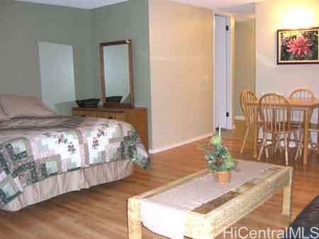 2572 Lemon Road, Unit 1106 Honolulu, HI 96815 - Photo 2 of 8 a bedroom with bed and a table