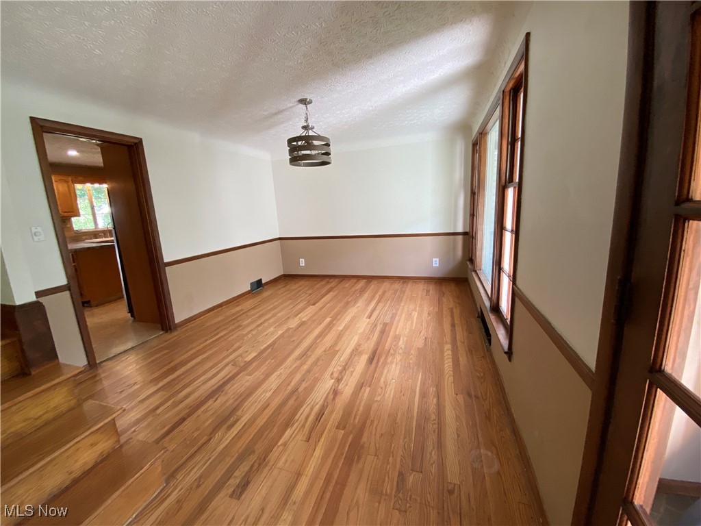 3601 Brinkmore Road Cleveland, OH 44121 - Photo 13 of 45 Unfurnished room with hardwood / wood-style flooring and a textured ceiling