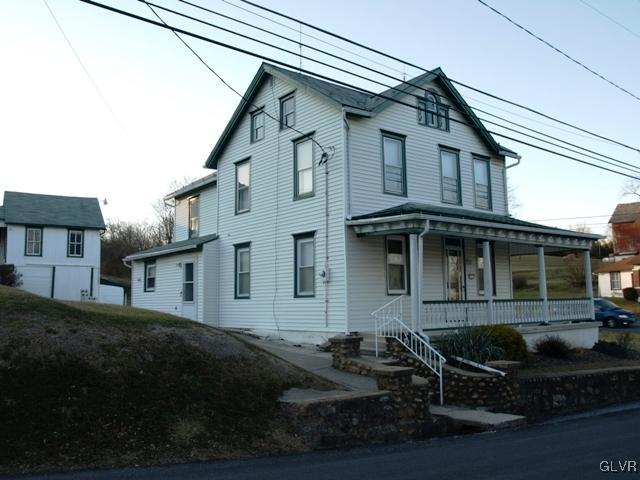 a front view of a house with yard