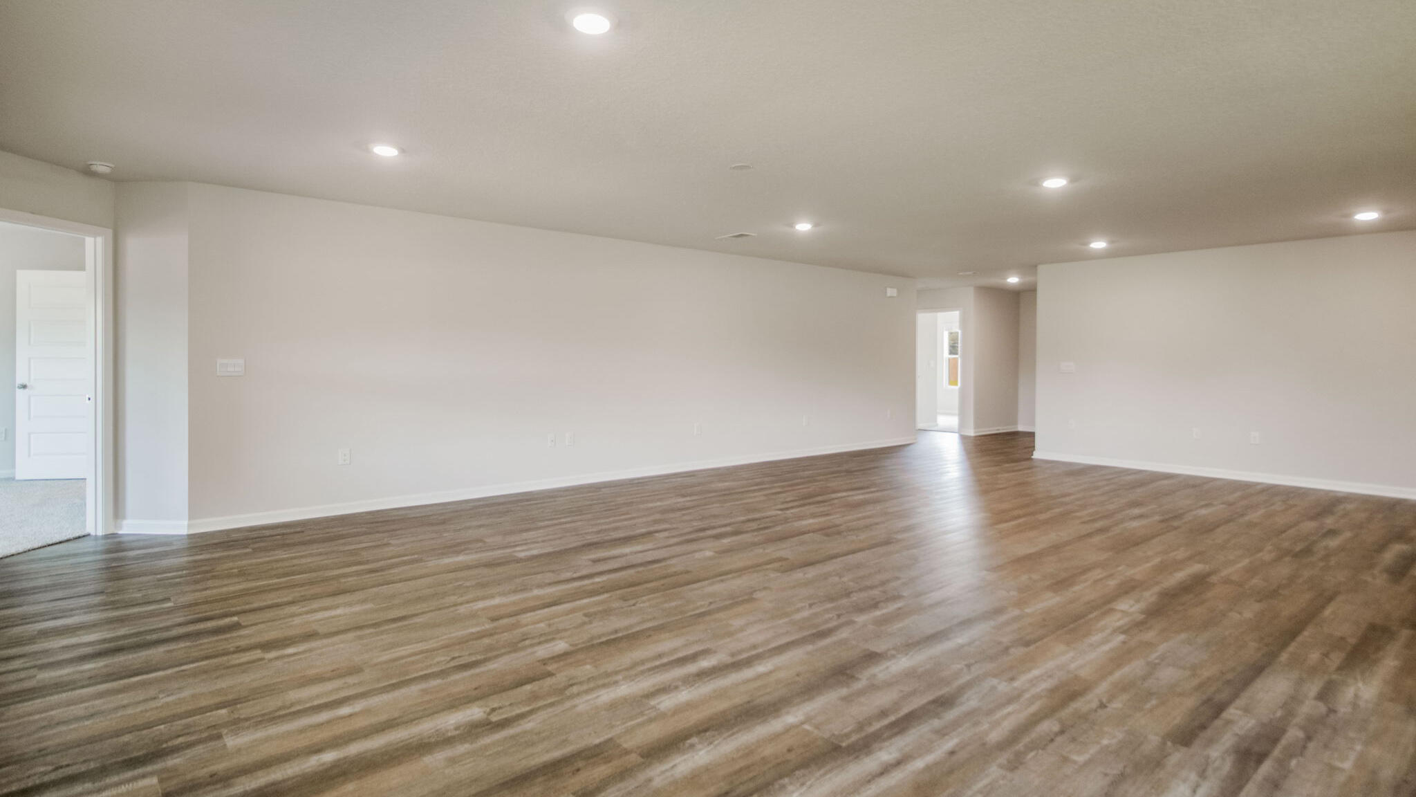 8701 Bluebell Street Milton, FL 32583 - Photo 14 of 32 a view of an empty room with wooden floor