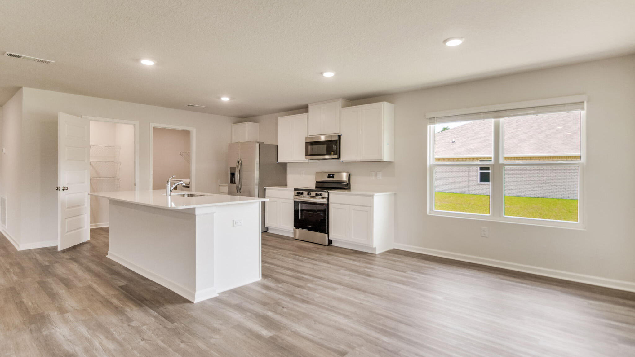 8701 Bluebell Street Milton, FL 32583 - Photo 2 of 32 a kitchen with stainless steel appliances granite countertop a stove and a sink