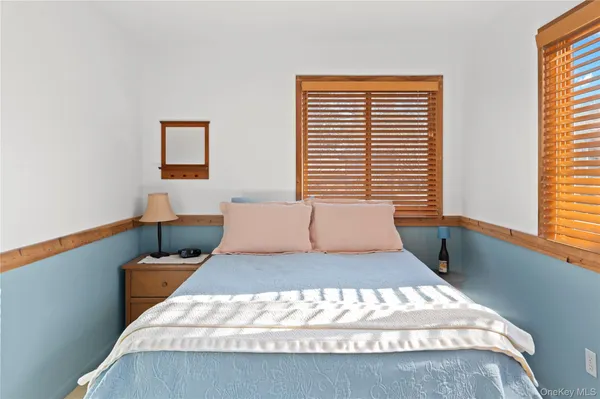 a bedroom with a large bed and a window