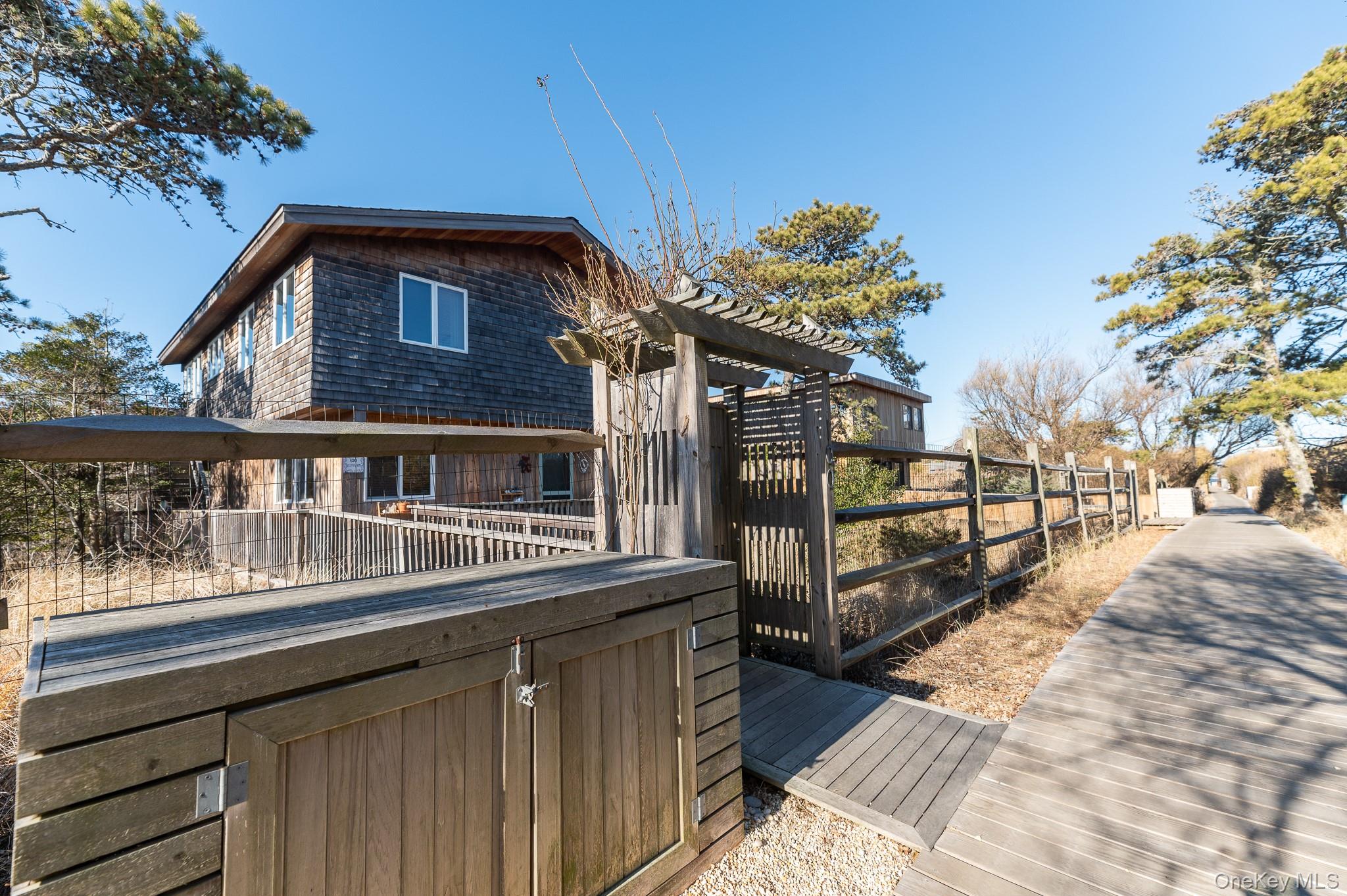 100 Clipper Way Ocean Beach, NY 11770 - Photo 37 of 46 a view of a house with a wooden fence