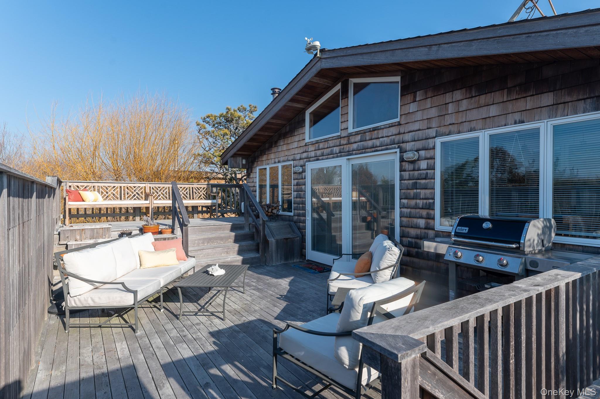 100 Clipper Way Ocean Beach, NY 11770 - Photo 42 of 46 a roof deck with table and chairs and wooden floor